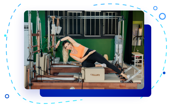 Pilates instructor using a reformer machine
